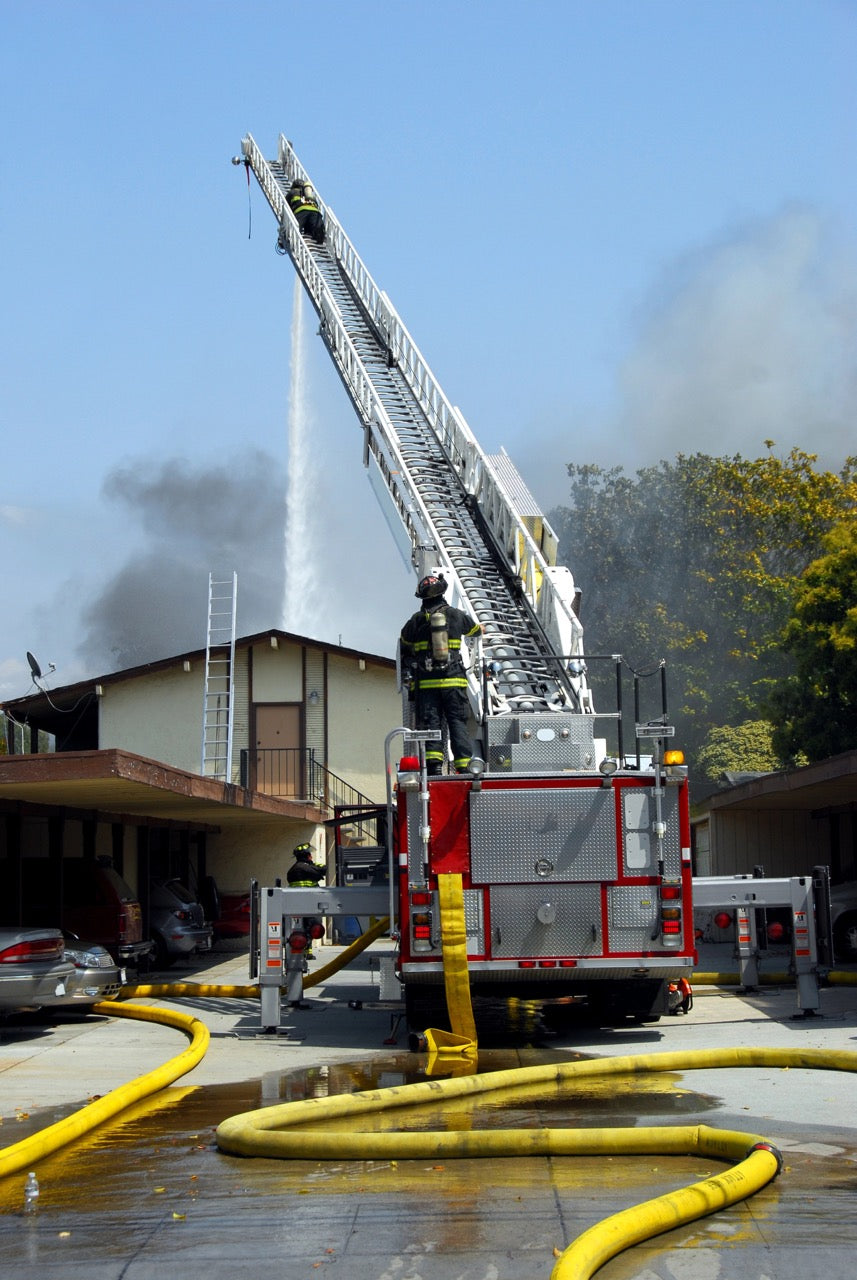 Sacramento City firefighters using an elevated stream during a structure fire.
